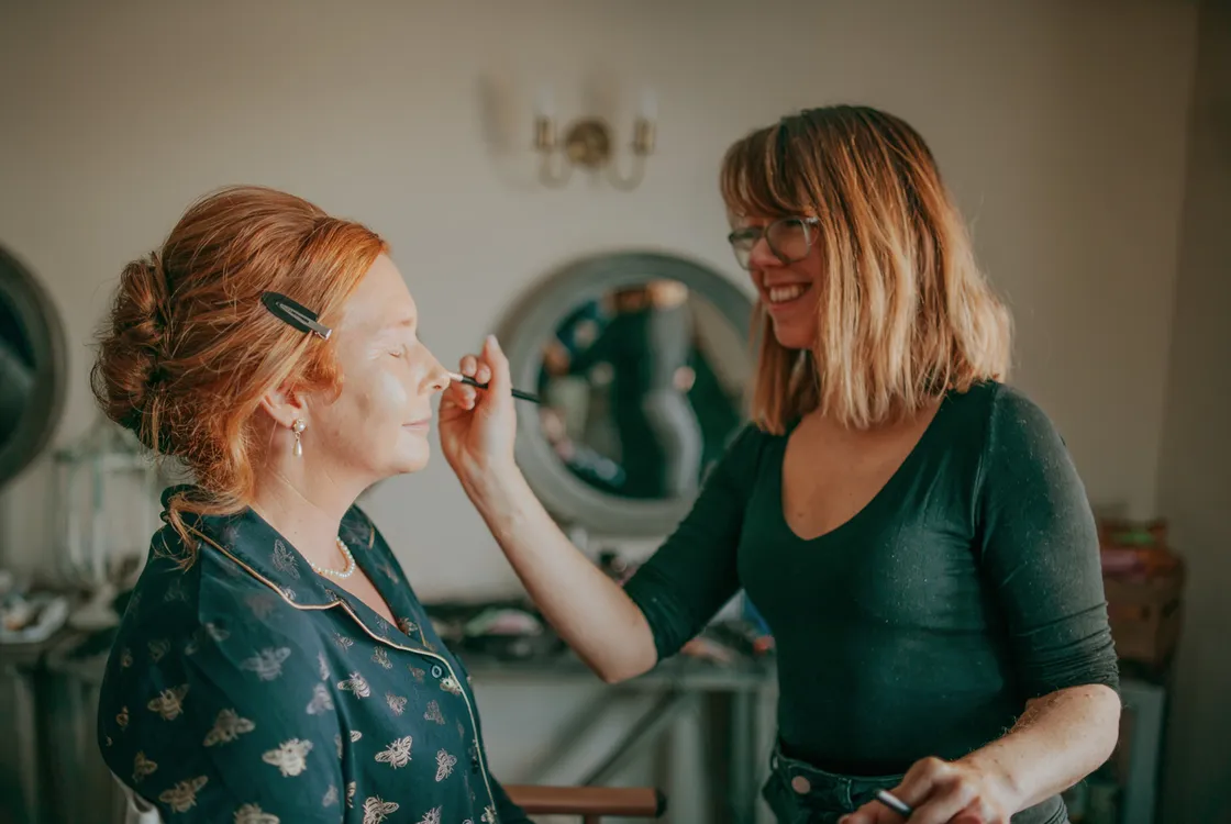 Holly applying make-up to a female client