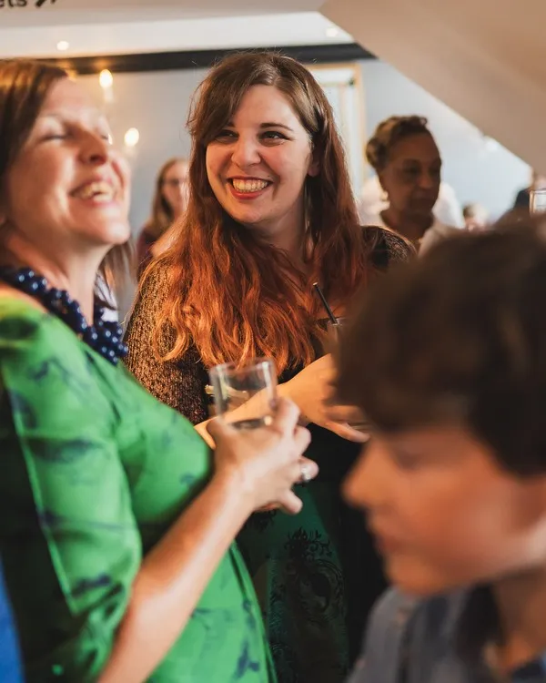 Rachel smiling at a wedding guest